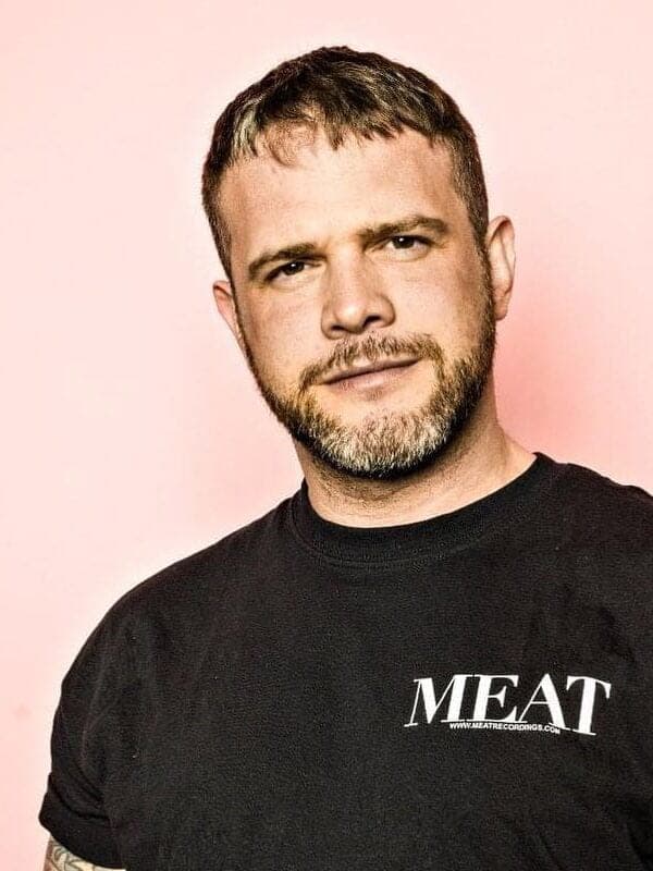 Gerald VDH im schwarzen MEAT-Shirt vor rosa Hintergrund.